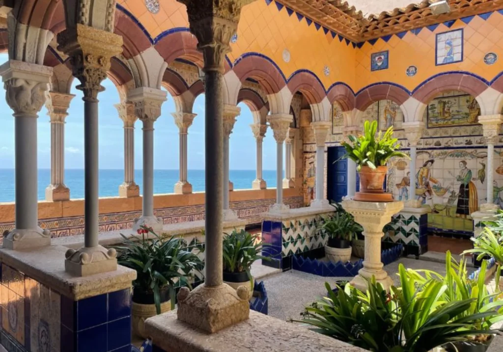 Interior gallery of Palau Maricel with ornate arches, tilework and sea views