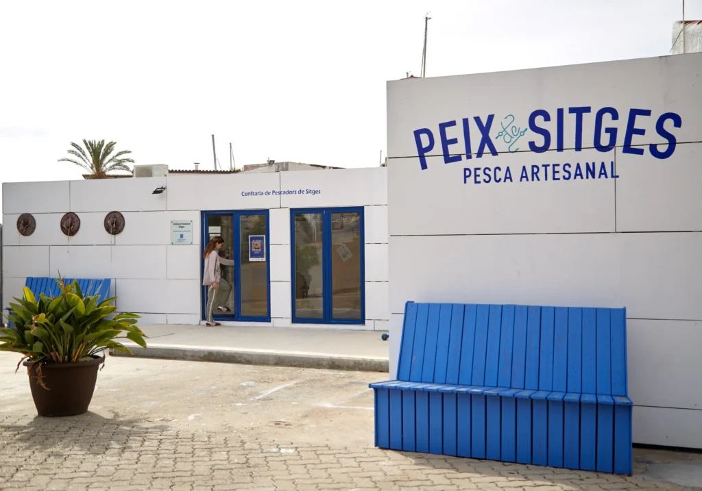Façade of the Peix Sitges fishermen's cooperative with an artisan fishing sign