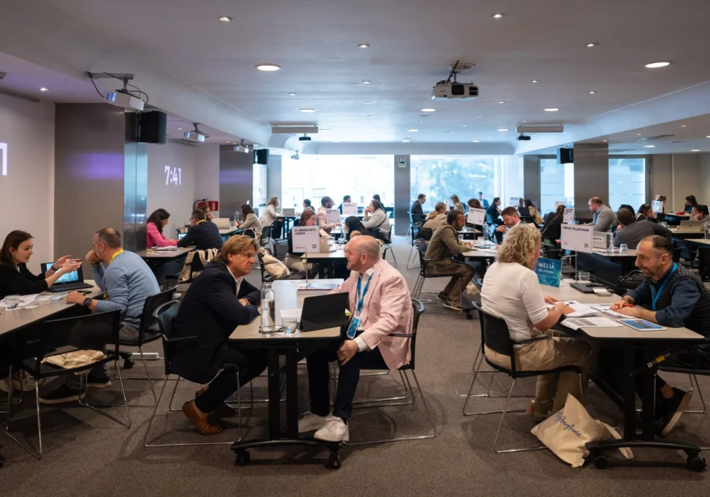 Meeting room with professionals taking part in individual B2B meetings