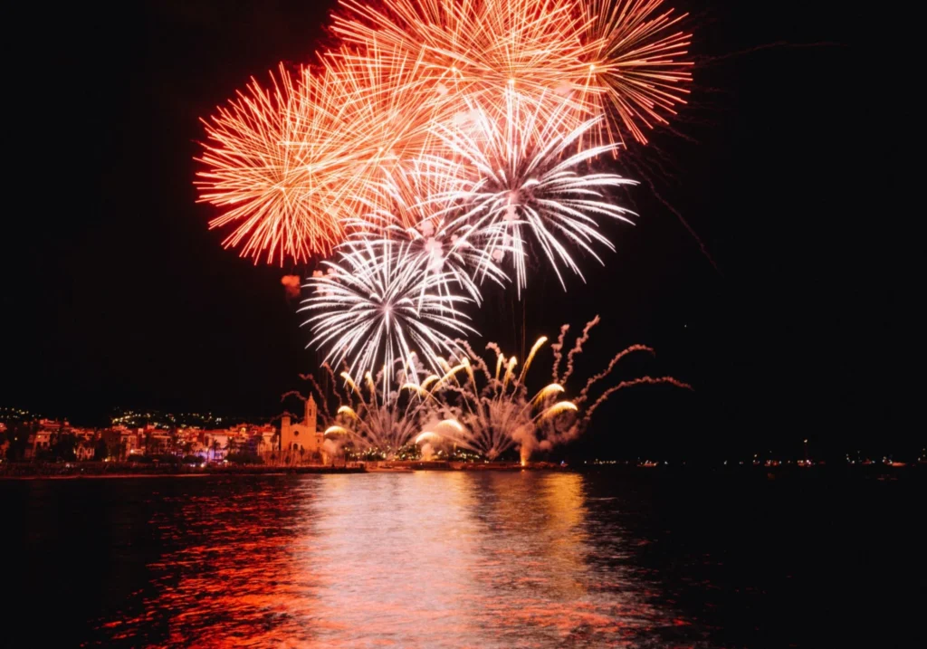 Fireworks display over the sea along the Sitges coastline at night