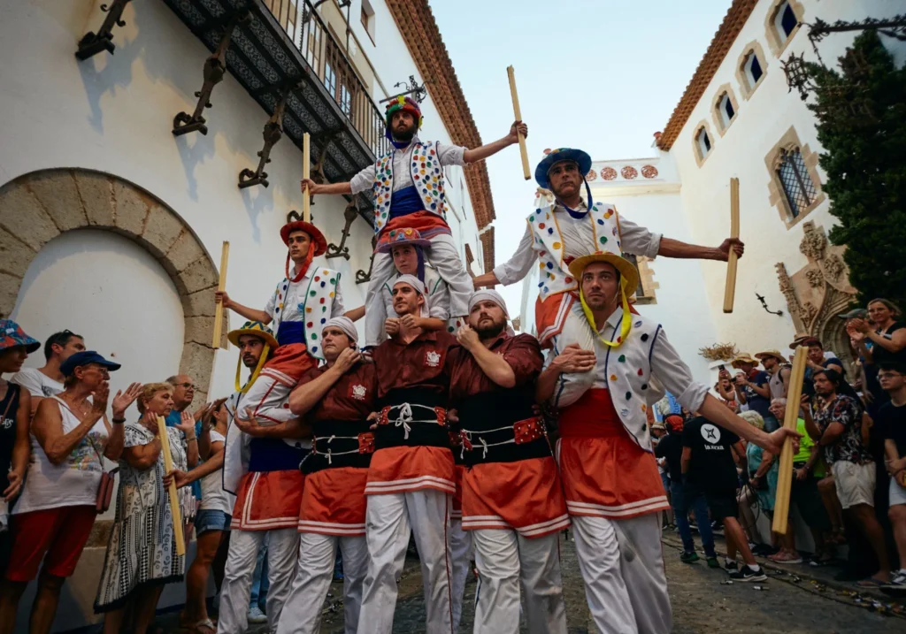 Castellers building a human tower in Sitges square during a traditional festival