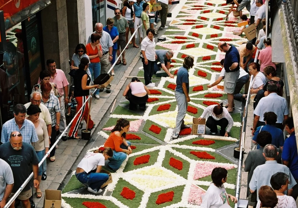 Residents making flower carpets in the street during Corpus Christi celebrations in Sitges