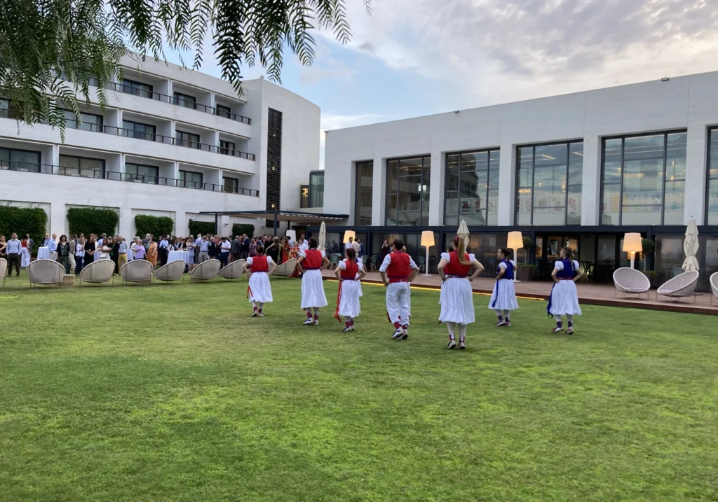 Traditional Catalan dancers performing in the garden of a Sitges hotel at dusk